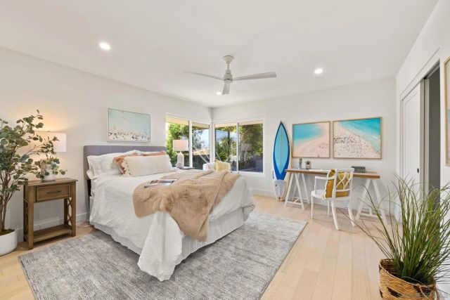 a view of a house with a big yard patio and a yard