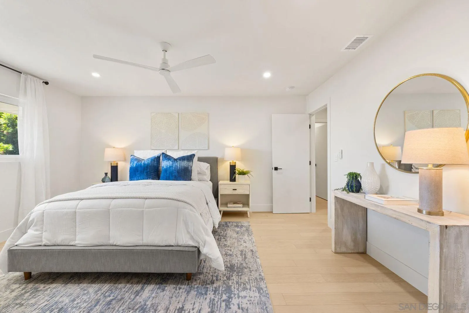 896 La Jolla Rancho Road La Jolla, CA 92037 - Photo 53 of 54 a bedroom with a large bed and a chandelier