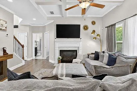 a living room with furniture fireplace and flat screen tv