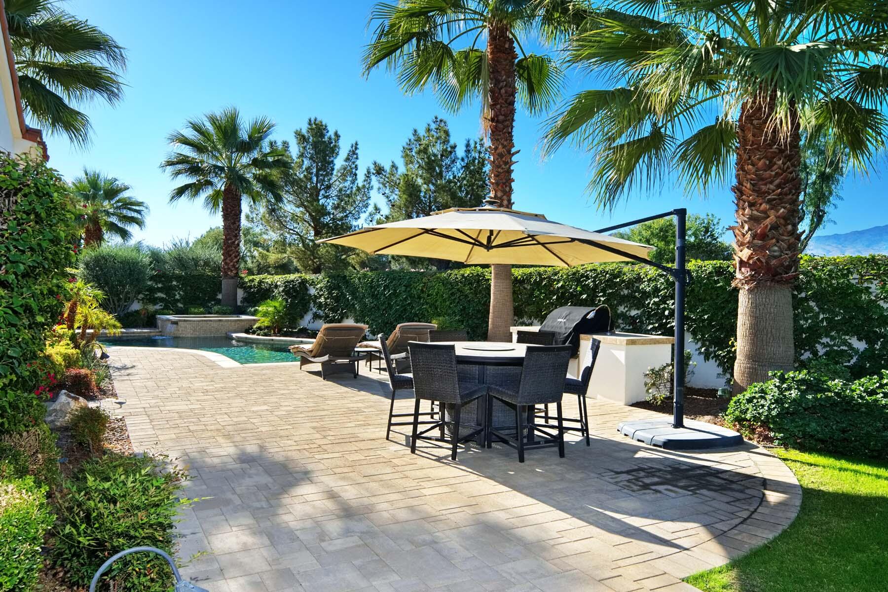 76054 Via Saturnia Indian Wells, CA 92210 - Photo 11 of 61 a view of a backyard with a sitting area and furniture