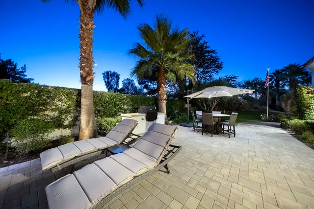 a living room with patio furniture and a potted plants