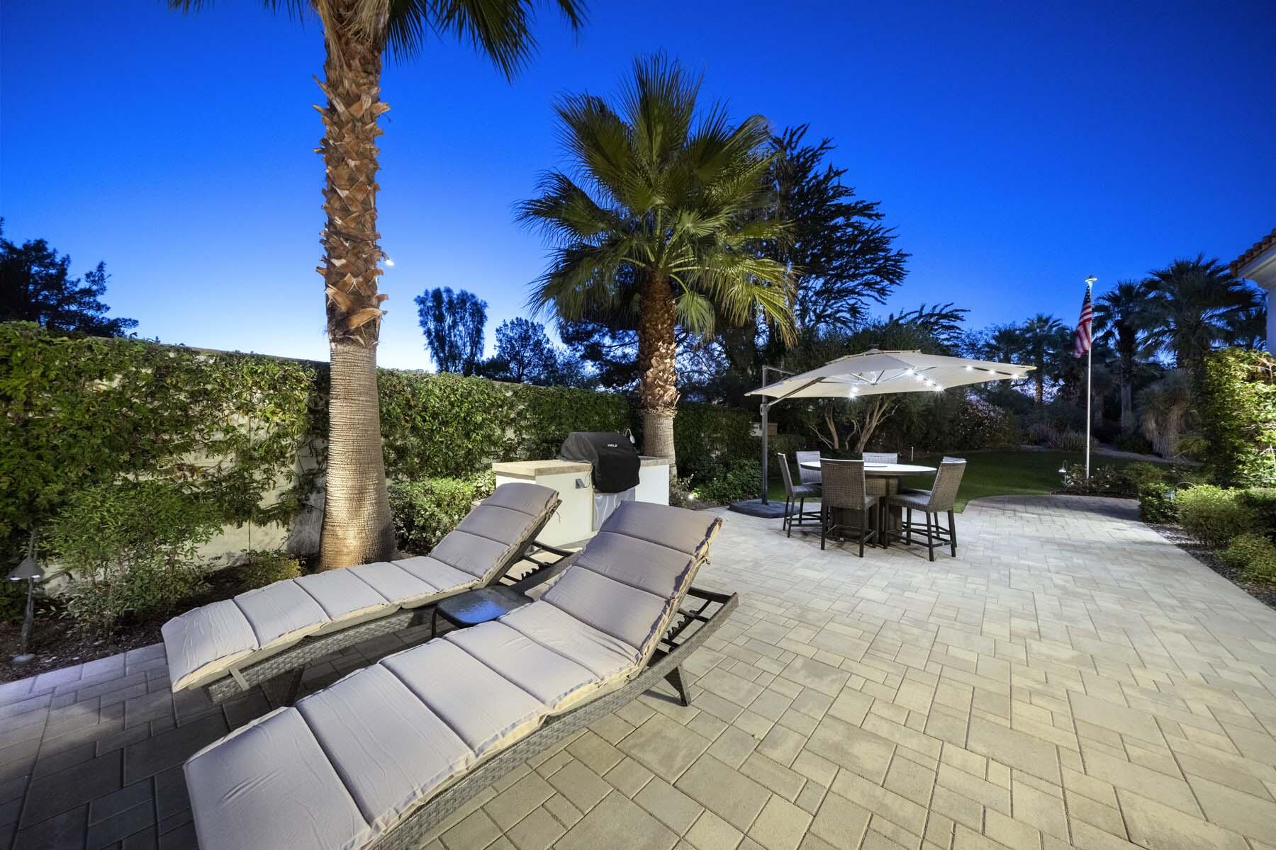 76054 Via Saturnia Indian Wells, CA 92210 - Photo 16 of 61 a view of backyard with seating space and trees