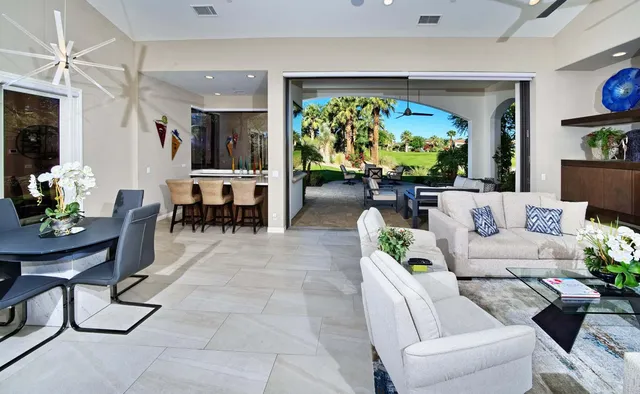 a outdoor living space with furniture potted plant and a fireplace