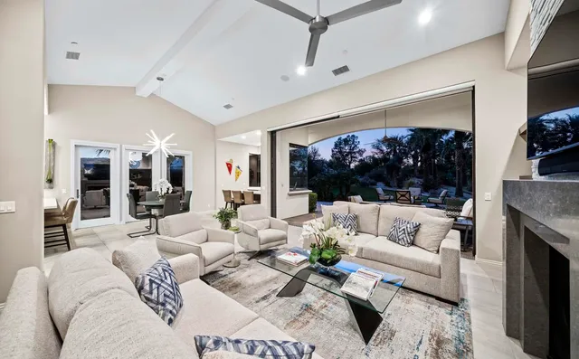 a view of a patio with couches table and chairs and potted plants