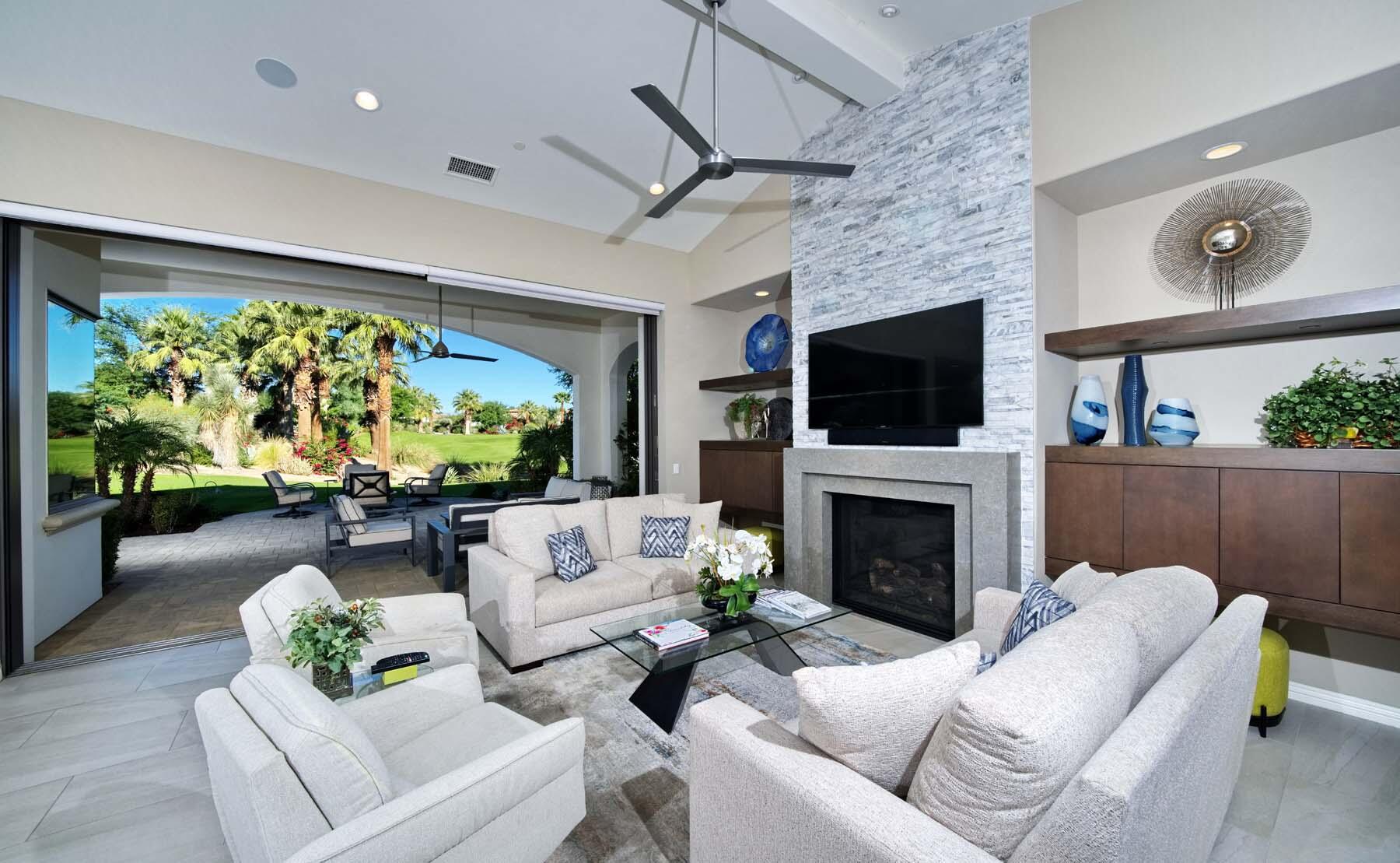 76054 Via Saturnia Indian Wells, CA 92210 - Photo 19 of 61 a living room with furniture a fireplace and a flat screen tv