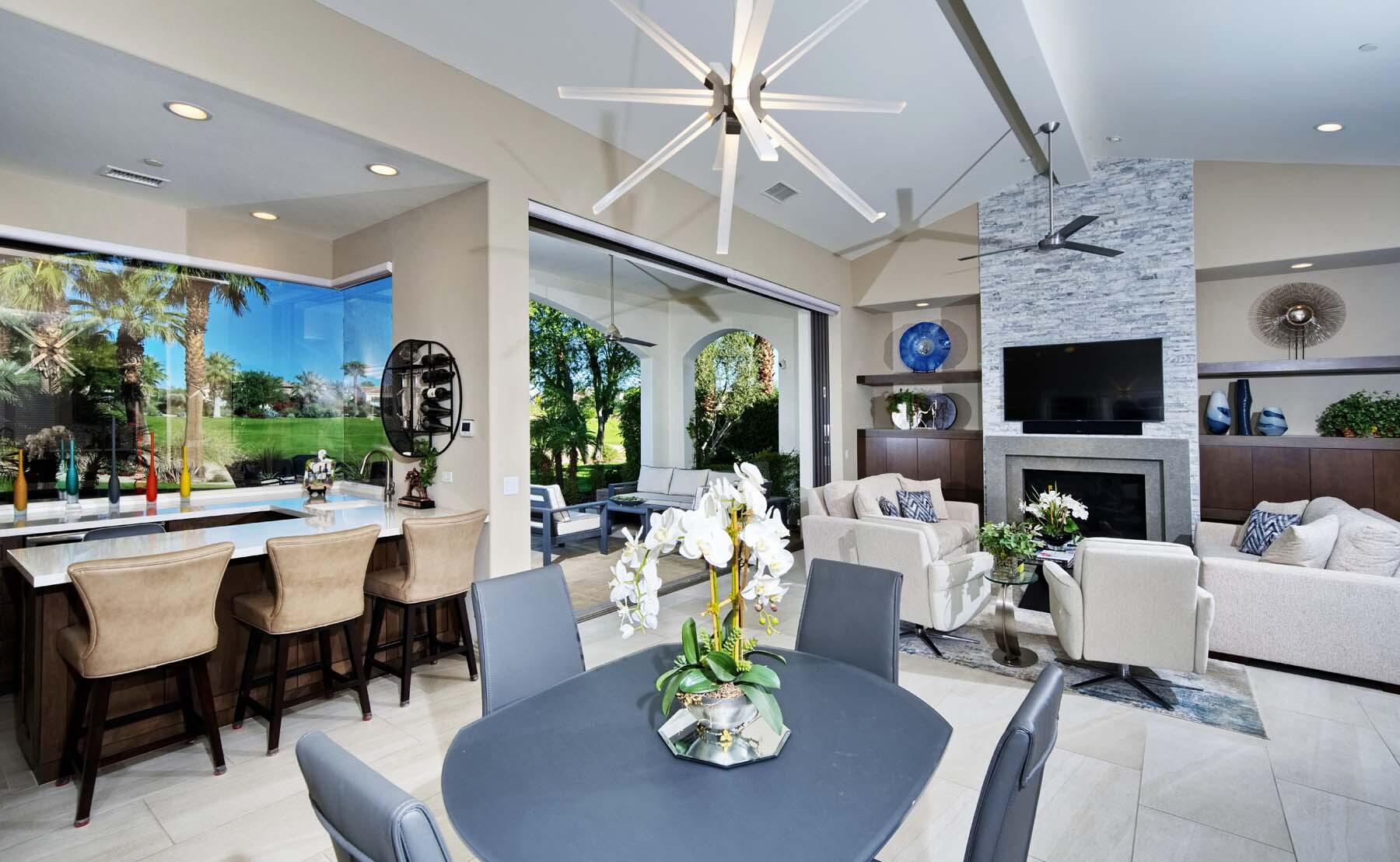 76054 Via Saturnia Indian Wells, CA 92210 - Photo 20 of 61 a living room with furniture a flat screen tv and a large window