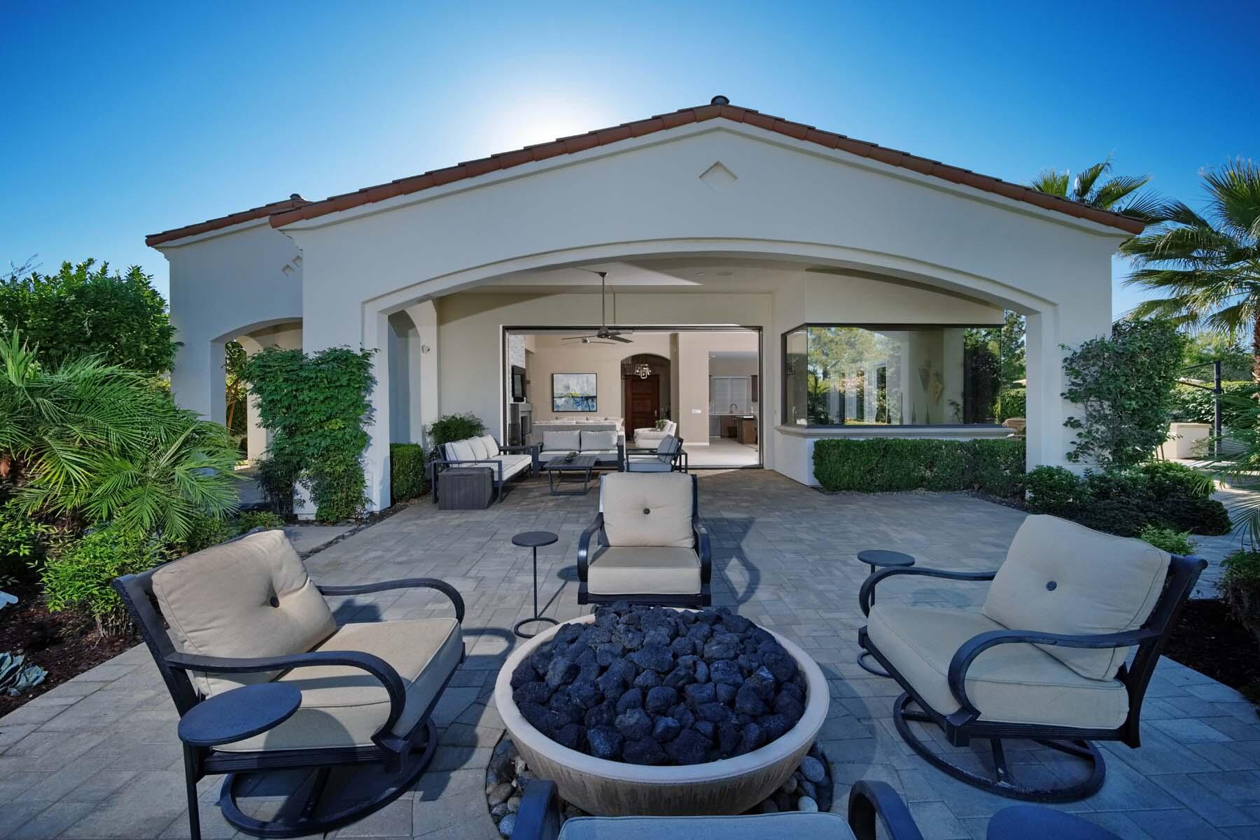 76054 Via Saturnia Indian Wells, CA 92210 - Photo 27 of 61 a view of a patio with couches table and chairs and potted plants