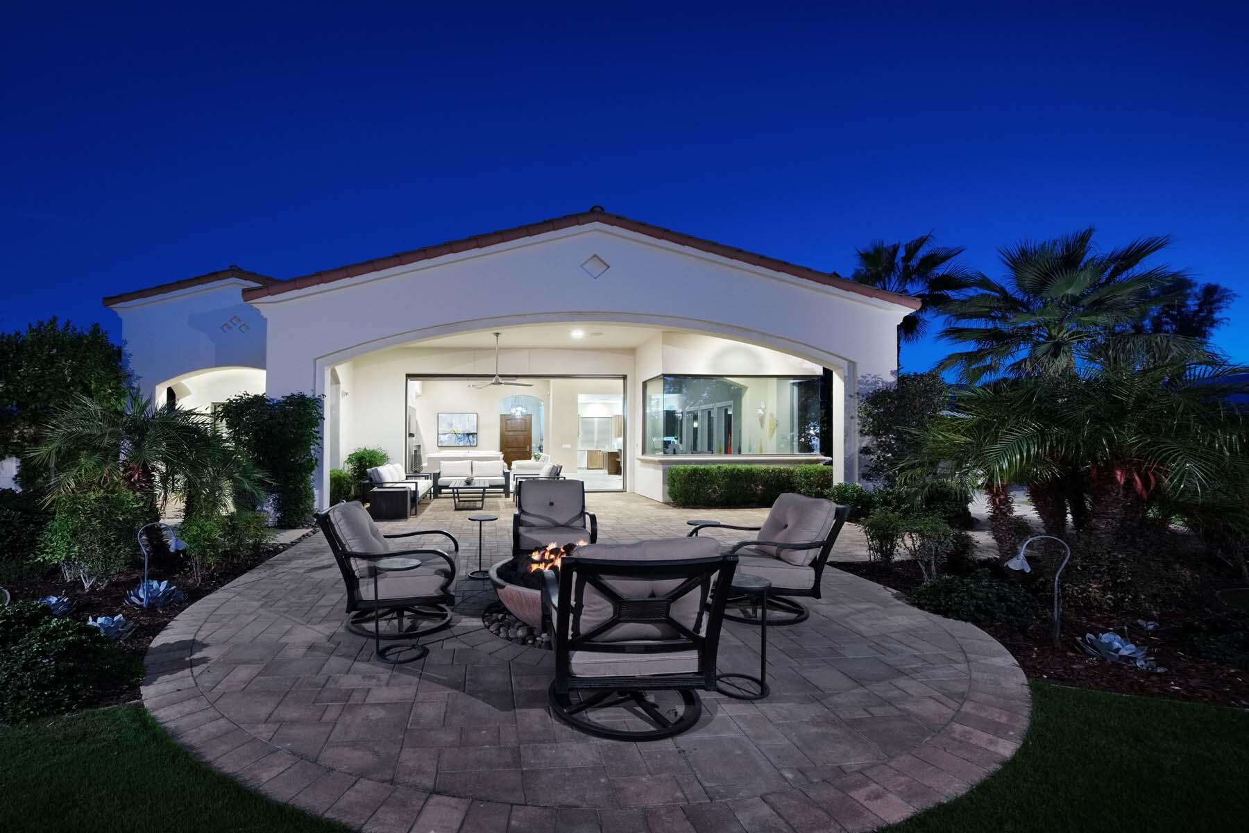 76054 Via Saturnia Indian Wells, CA 92210 - Photo 28 of 61 a view of a house with backyard sitting area and garden