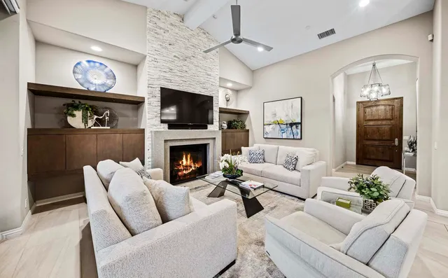 a bedroom with a large bed and a chandelier