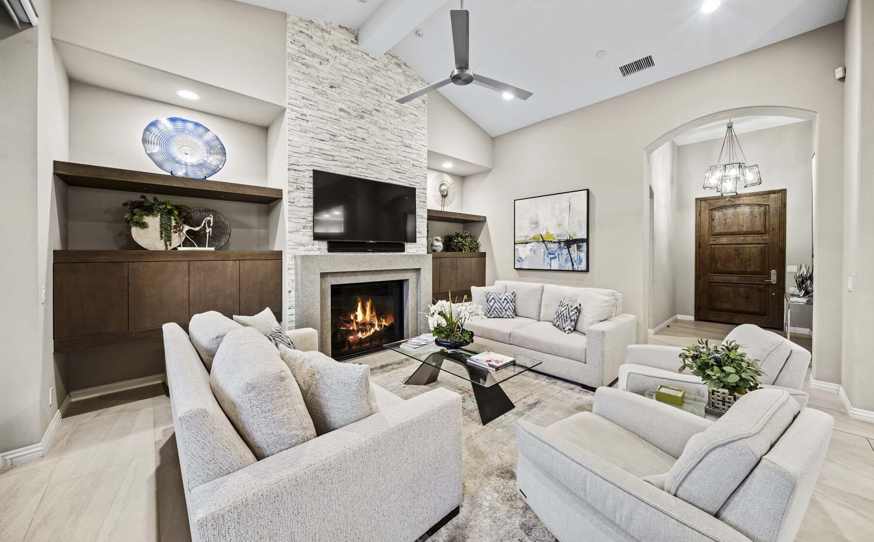76054 Via Saturnia Indian Wells, CA 92210 - Photo 33 of 61 a living room with furniture a flat screen tv and a fireplace