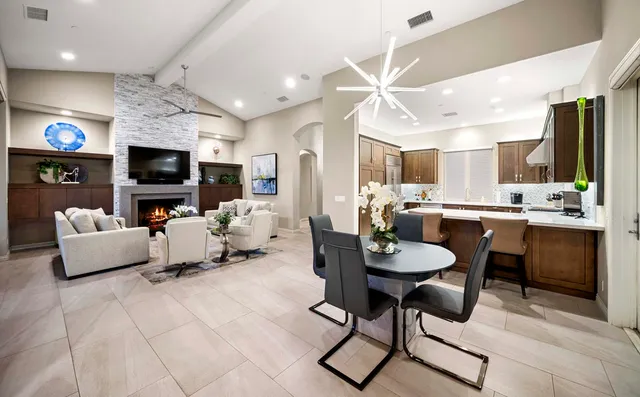 a bedroom with a large bed a couch and a flat screen tv