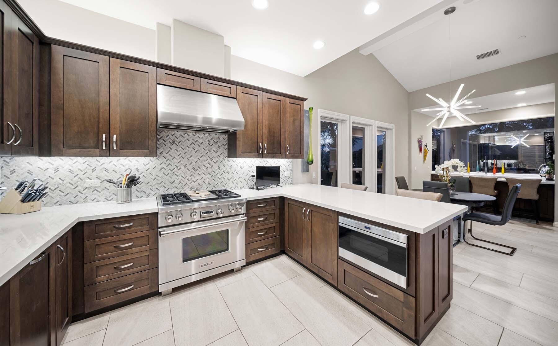 76054 Via Saturnia Indian Wells, CA 92210 - Photo 38 of 61 a kitchen with stainless steel appliances granite countertop a stove and a sink