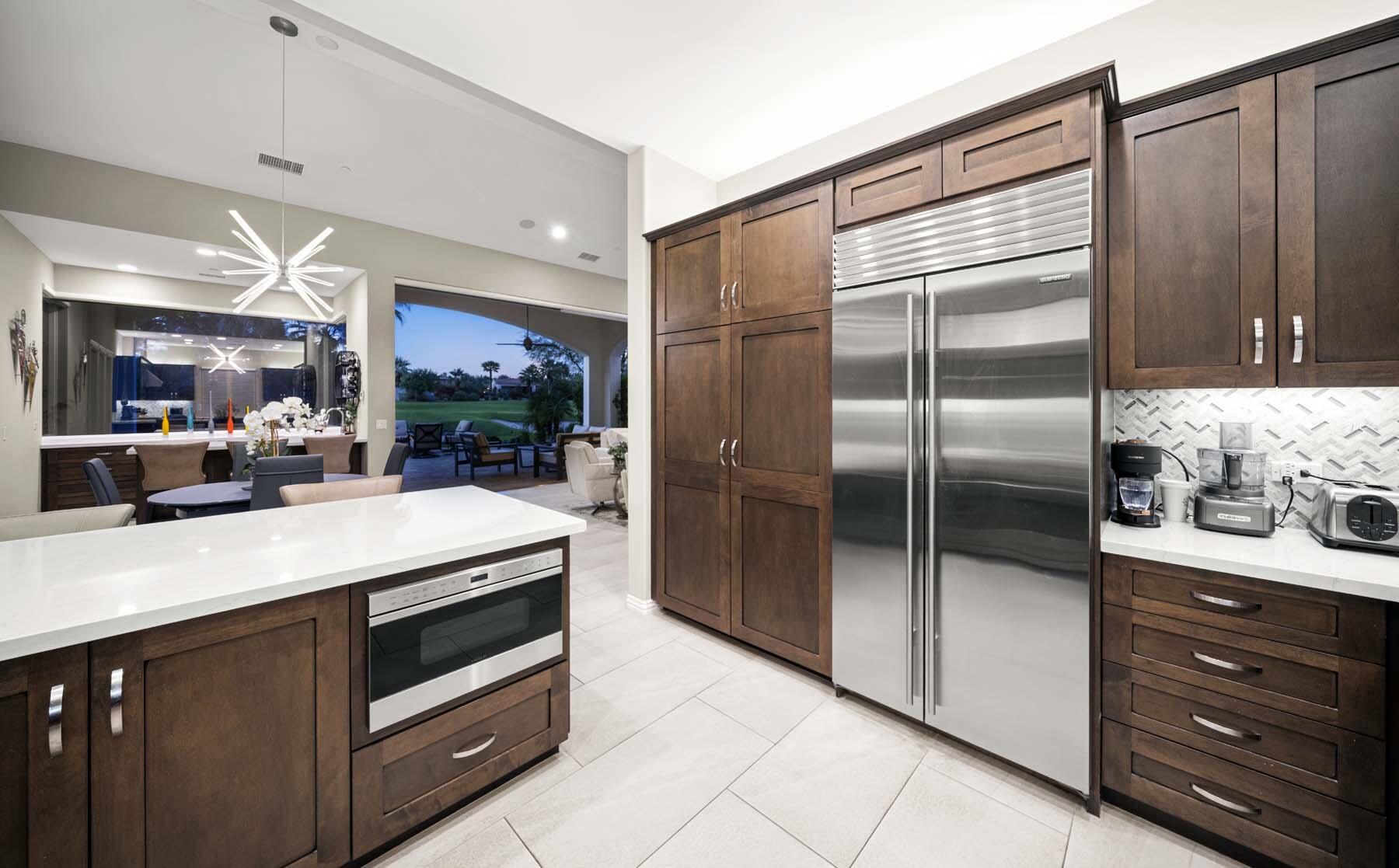 76054 Via Saturnia Indian Wells, CA 92210 - Photo 39 of 61 a kitchen with stainless steel appliances kitchen island granite countertop a refrigerator and a sink