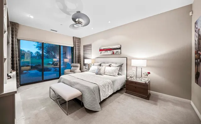 a bedroom with a bed couch and window