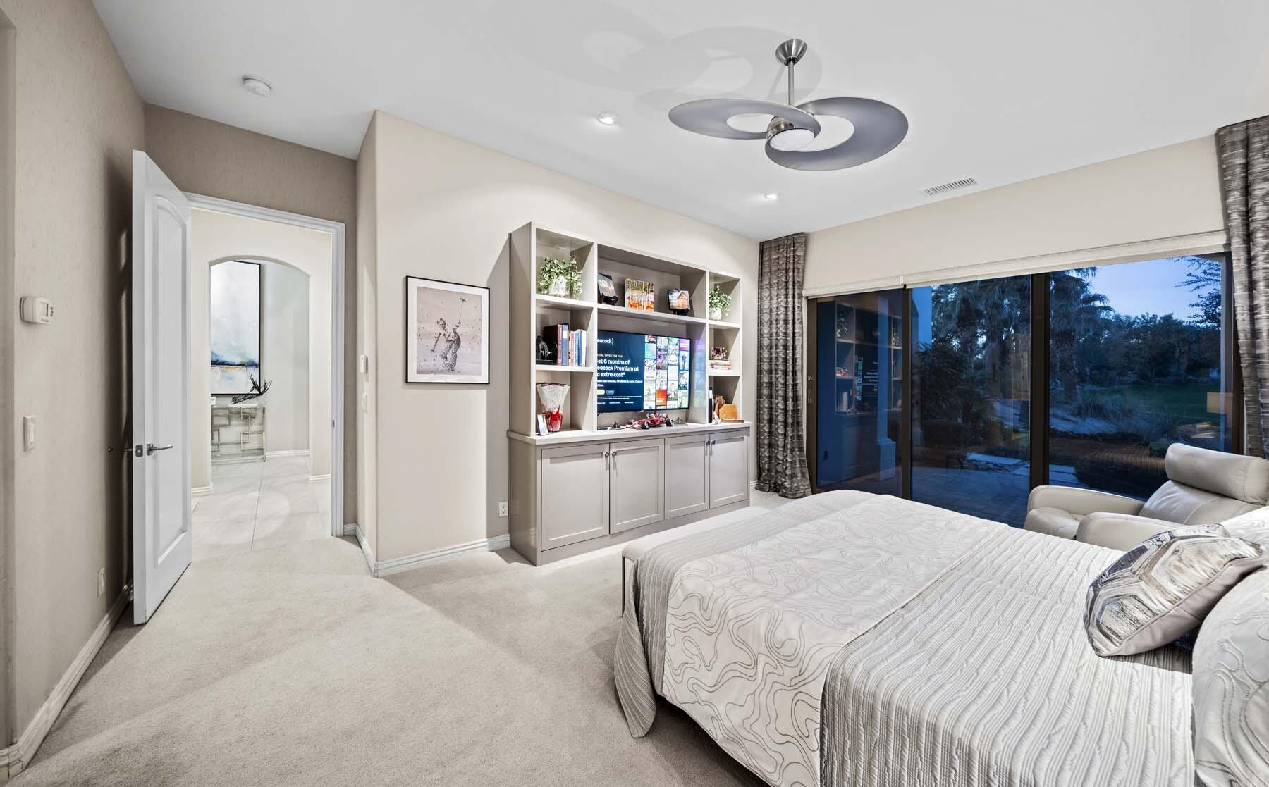 76054 Via Saturnia Indian Wells, CA 92210 - Photo 43 of 61 a bedroom with a large bed and a chandelier