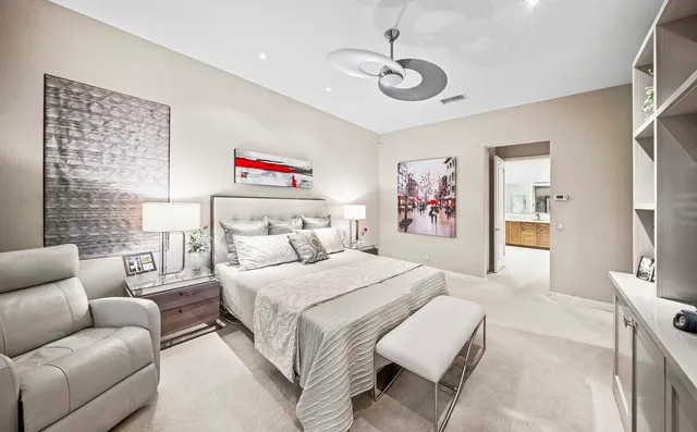 a spacious bedroom with a bed couch and a window