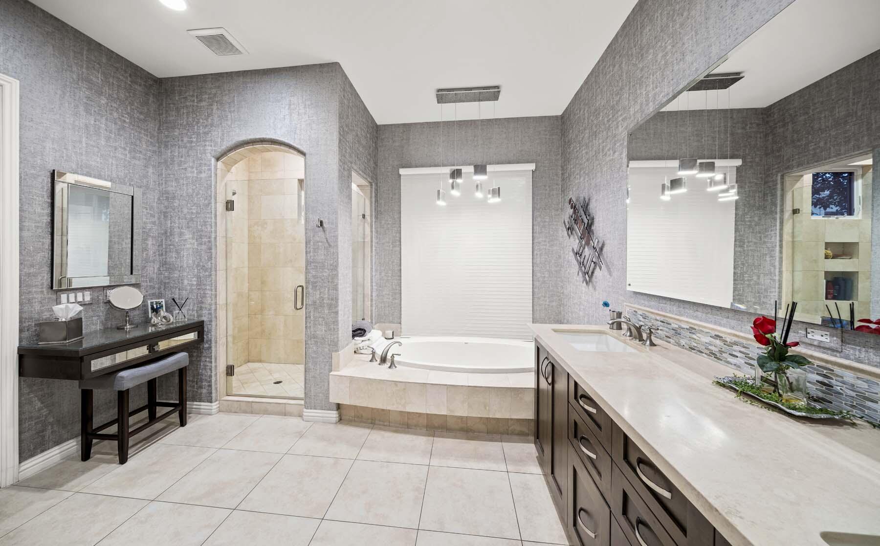 76054 Via Saturnia Indian Wells, CA 92210 - Photo 46 of 61 a spacious bathroom with a double vanity sink a mirror a bathtub and shower