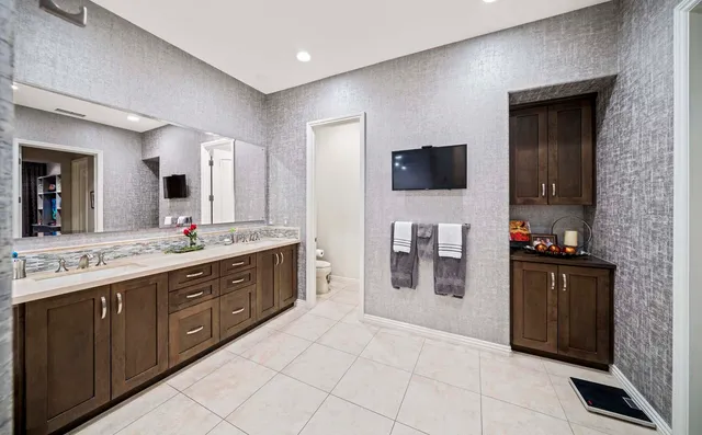 a bathroom with a tub sink shower and mirror