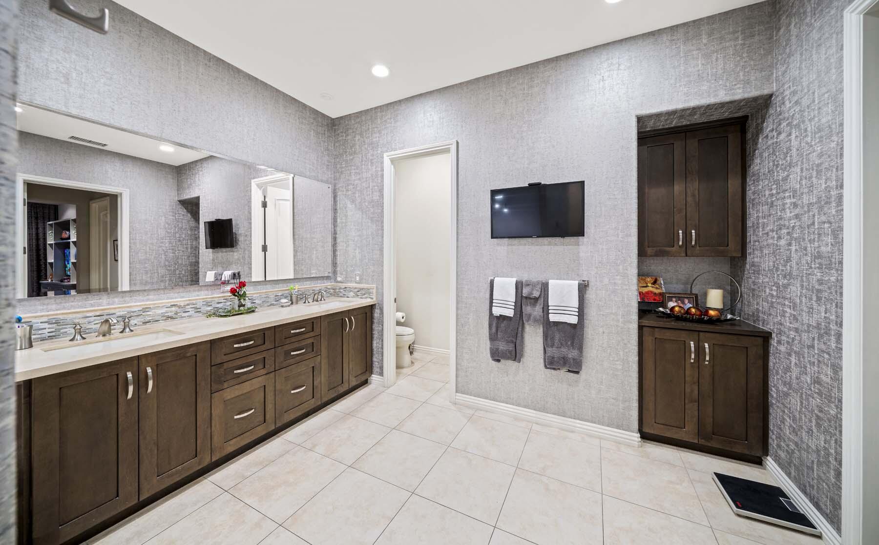 76054 Via Saturnia Indian Wells, CA 92210 - Photo 47 of 61 a spacious bathroom with a sink and a mirror