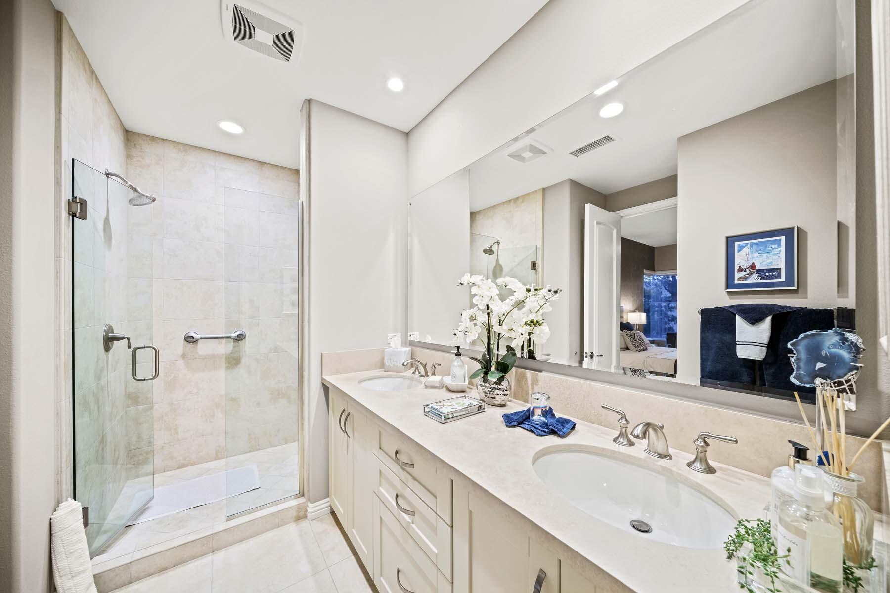76054 Via Saturnia Indian Wells, CA 92210 - Photo 52 of 61 a bathroom with a double vanity sink mirror and shower