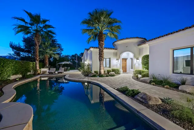 a house with palm tree in front of it