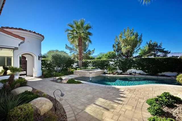 a view of a patio with table and chairs potted plants and palm trees