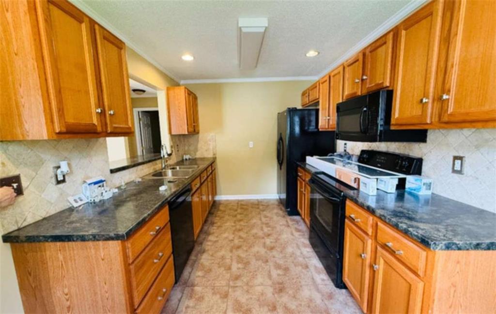 153 Crest Pointe Bremen, GA 30110 - Photo 8 of 24 a kitchen with stainless steel appliances granite countertop a stove a sink and a microwave