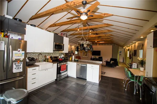 a kitchen with a sink a stove and cabinets