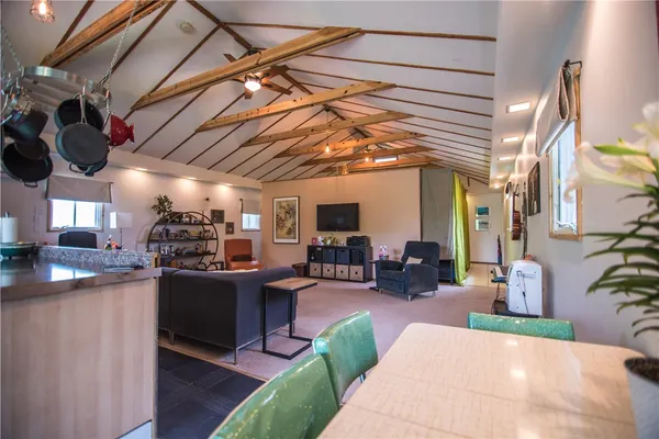 a living room with lots of furniture and kitchen view