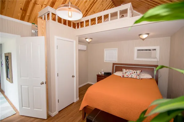 a bed room with a bed and a chair