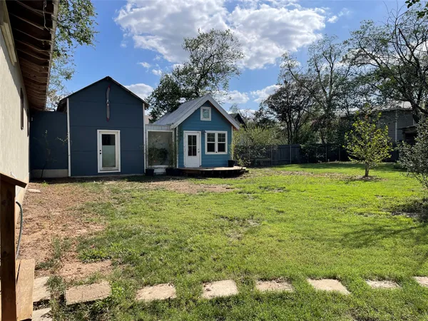 a front view of house with yard and trees