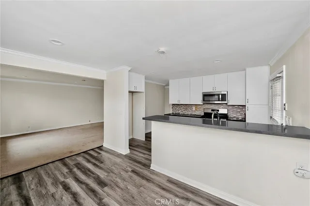 a kitchen with stainless steel appliances a sink and a stove