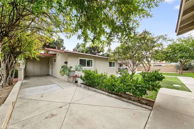 a view of a house with yard and a garden