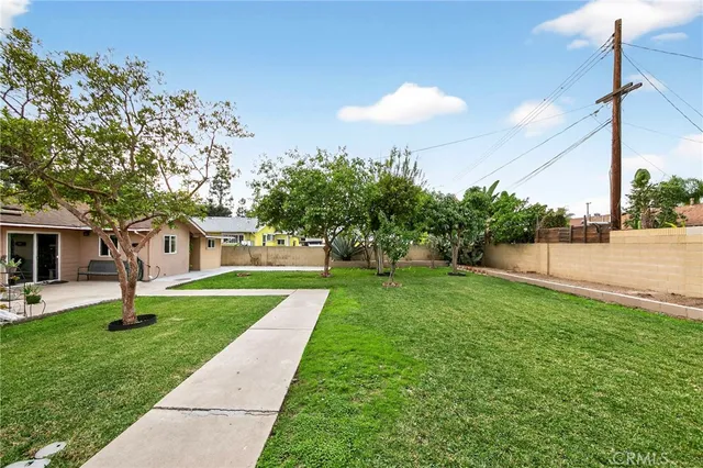 a view of a house with a yard and tree s