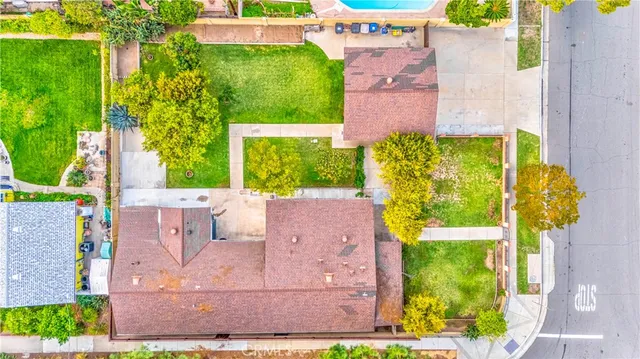 an aerial view of a house with a yard basket ball court and outdoor seating