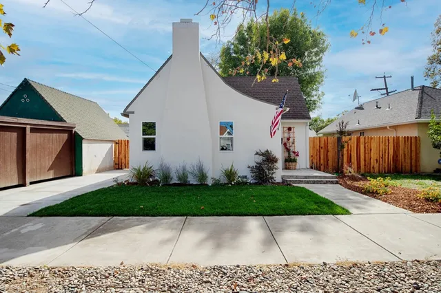 a view of a white house with a yard