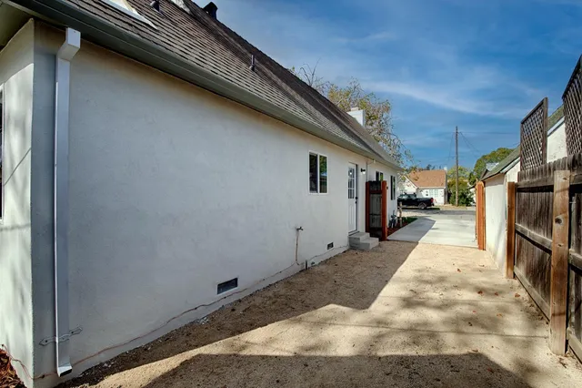 a backyard of a house with potted plants