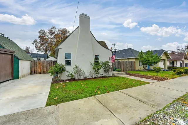 a view of a kitchen with wooden floor and a refrigerator