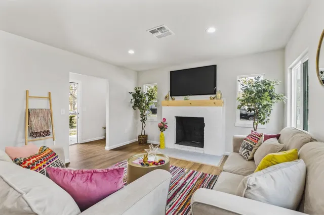 a living room with furniture and wooden floor