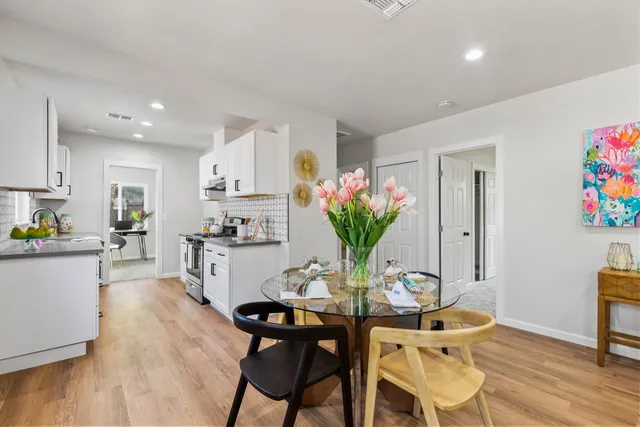 a view of a dining room with furniture and wooden floor