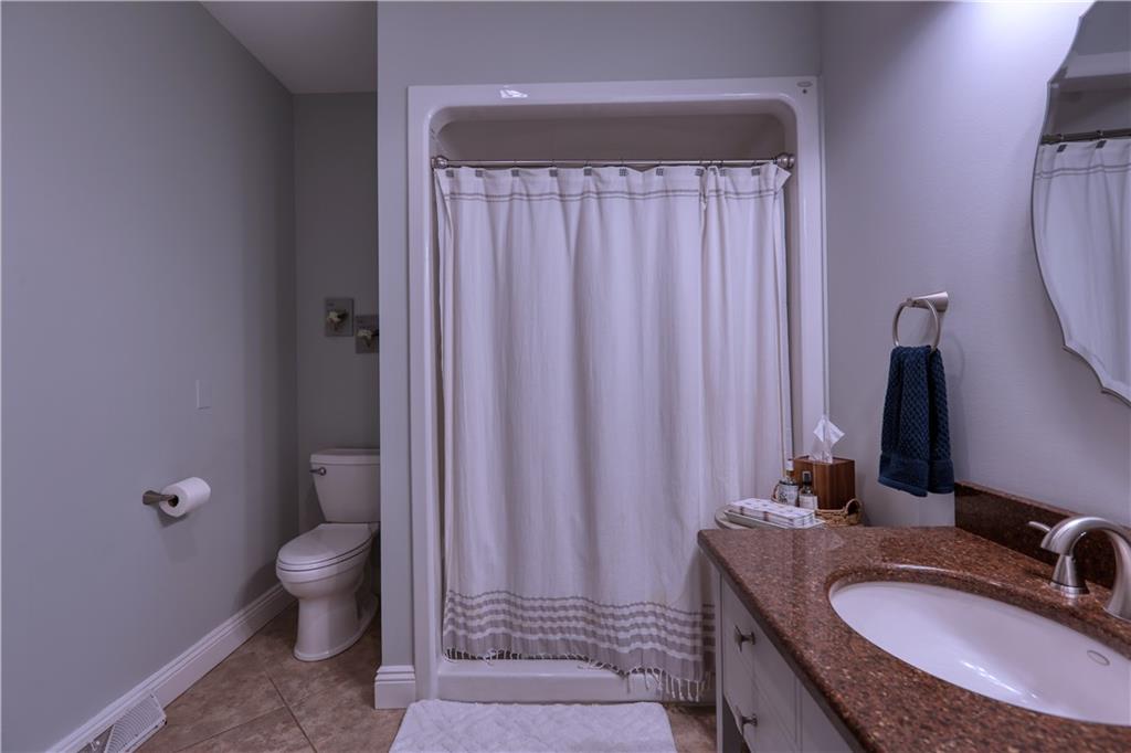230 Beacom Drive Beaver, PA 15009 - Photo 11 of 25 a bathroom with a granite countertop sink a toilet a mirror and shower curtain