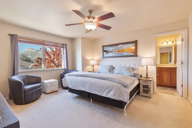 a bedroom with a large bed and a chandelier