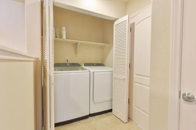 a spacious bedroom with a bed and a chandelier