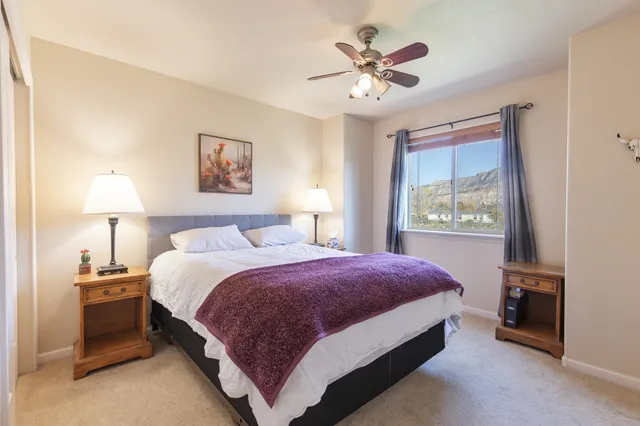 a bedroom with a bed and a lamp