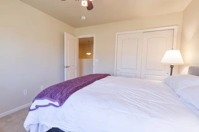 a bathroom with a granite countertop sink a mirror a bathtub and shower