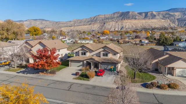 an aerial view of residential houses with outdoor space