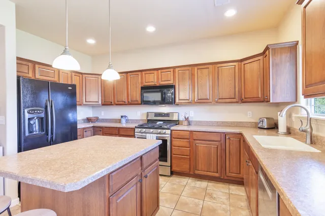 a kitchen with a sink stove and microwave