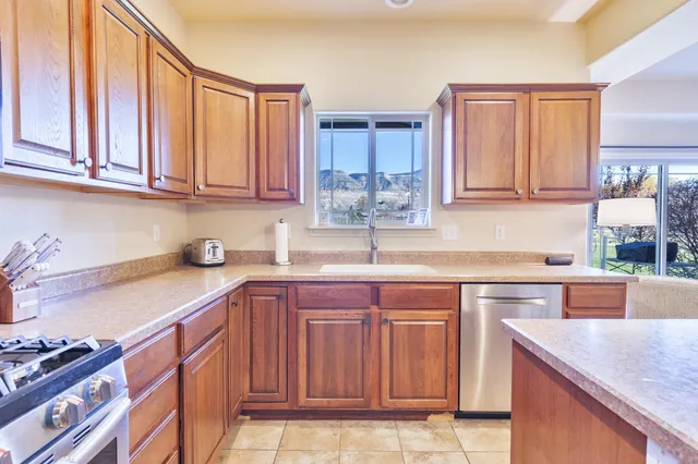 a kitchen with a refrigerator and a wooden floor