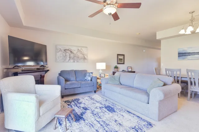 a living room with furniture and a floor to ceiling window