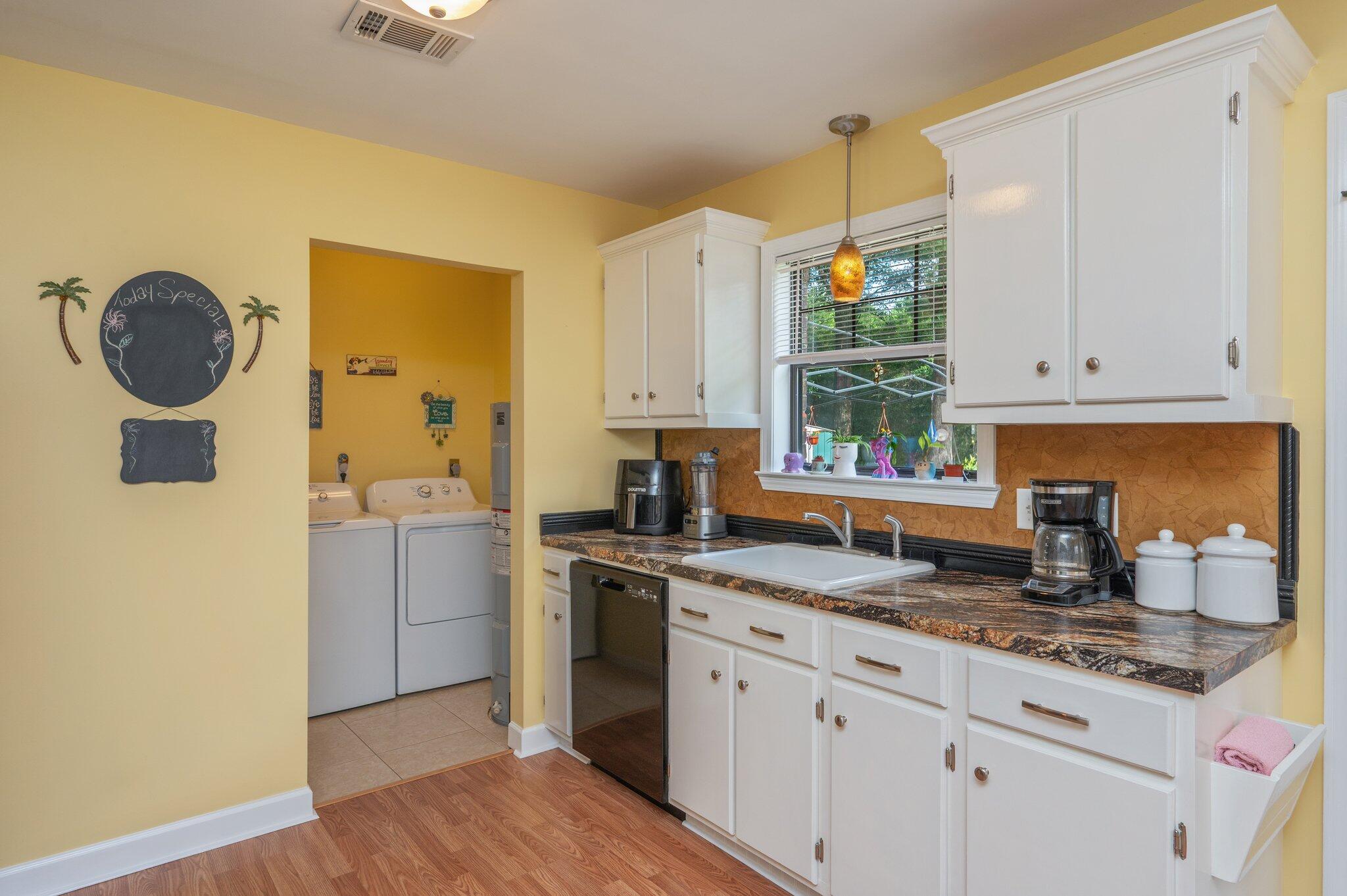 6256 Misty Lane Crestview, FL 32539 - Photo 11 of 39 a kitchen with granite countertop white cabinets and window